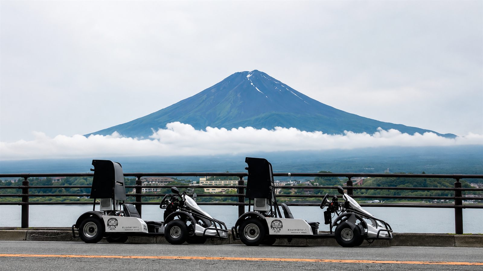 Electric go-karts by Lake Kawaguchiko with snow-capped Mt. Fuji
