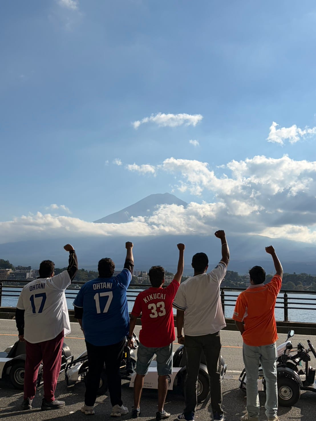A happy group celebrating together with Mt. Fuji views on an electric go-kart tour